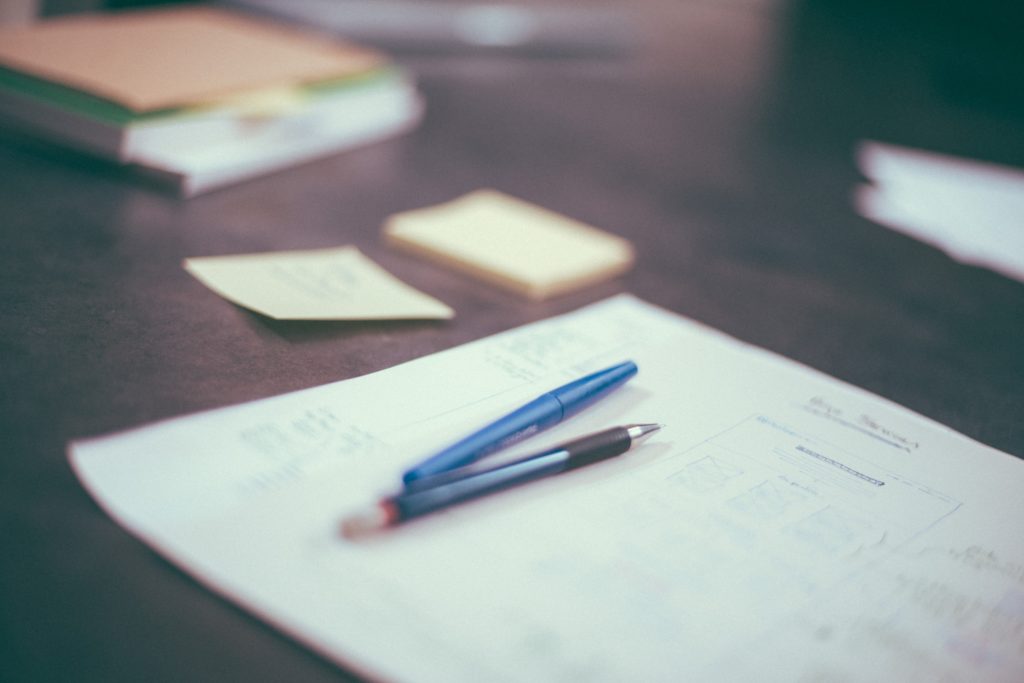 Pen and paper on desk.